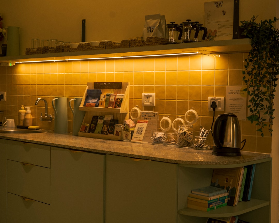 A cozy kitchen setup featuring a well-organized coffee and tea station with various mugs, a coffee maker, and tea accessories.